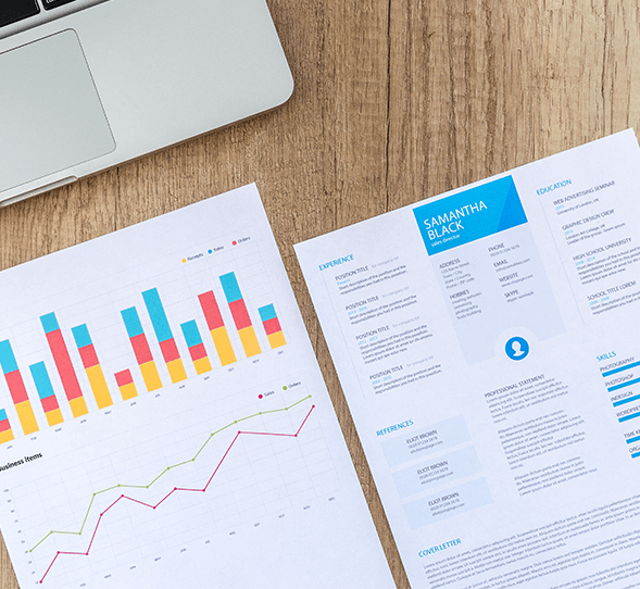 A resume and analytics sheet are shown on a desk
