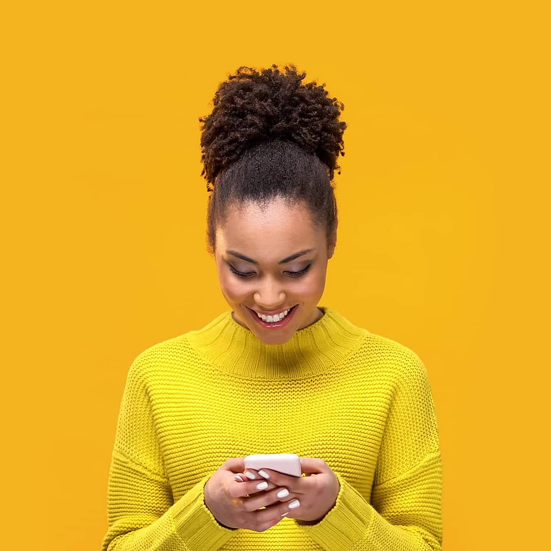 Woman looks at phone screen