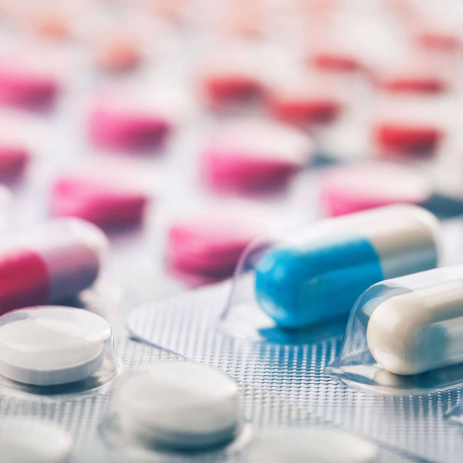 Heap of medical pills in white, blue and other colors. Pills in
