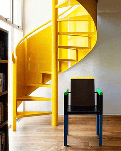 Yellow stairwell "The Archers" featuring the Palace Chair by George Sowden for Memphis Milano