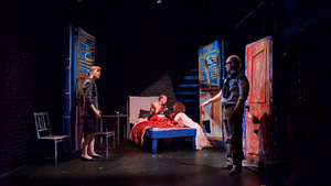 Actors are shown on a stage. Blue and Red hues contrast the dark tones.