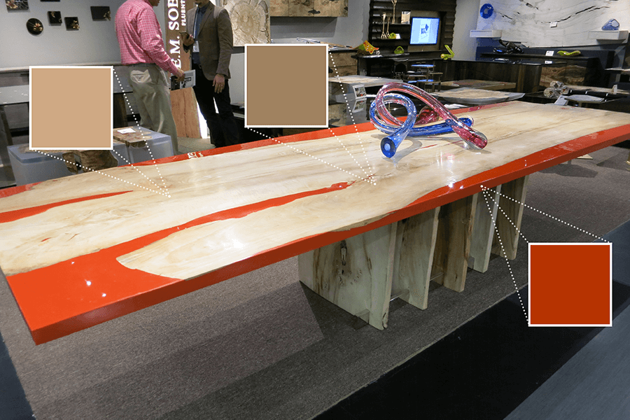 Em Soberon featured one of their beautiful dining tables. This one shows the bright orange epoxy and live-edge wood.
