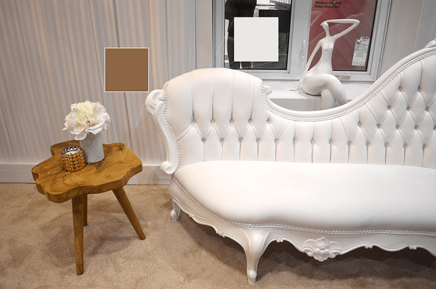 NettHaus' gorgeous white couch paired with a wooden side table