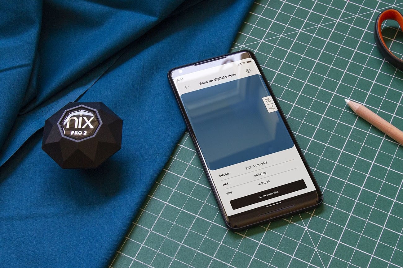 Nix Pro 2 with phone and shirt on green cutting mat