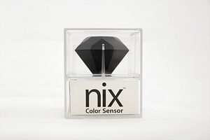 The Nix Pro sits on top of a white box with the Nix logo; which are both in a plastic casing