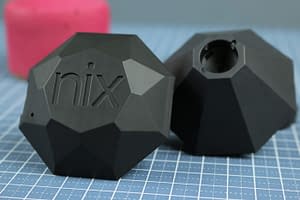 Two Nix Pros are shown: one shows the top of the device, the other is flipped so we see the bottom