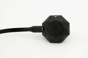 The Nix Mini has its charging cable plugged in