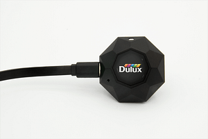 The Dulux Mini has its charging cable plugged in