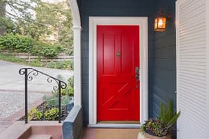 Front door painted red on cottage style home