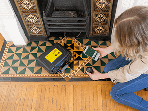 Woman scanning color by fireplace