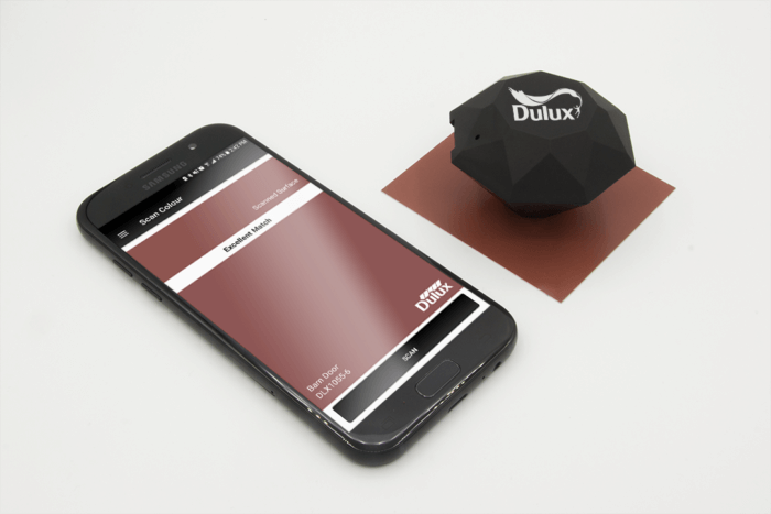 The Dulux Pro scans a red metal swatch; a phone displays the results